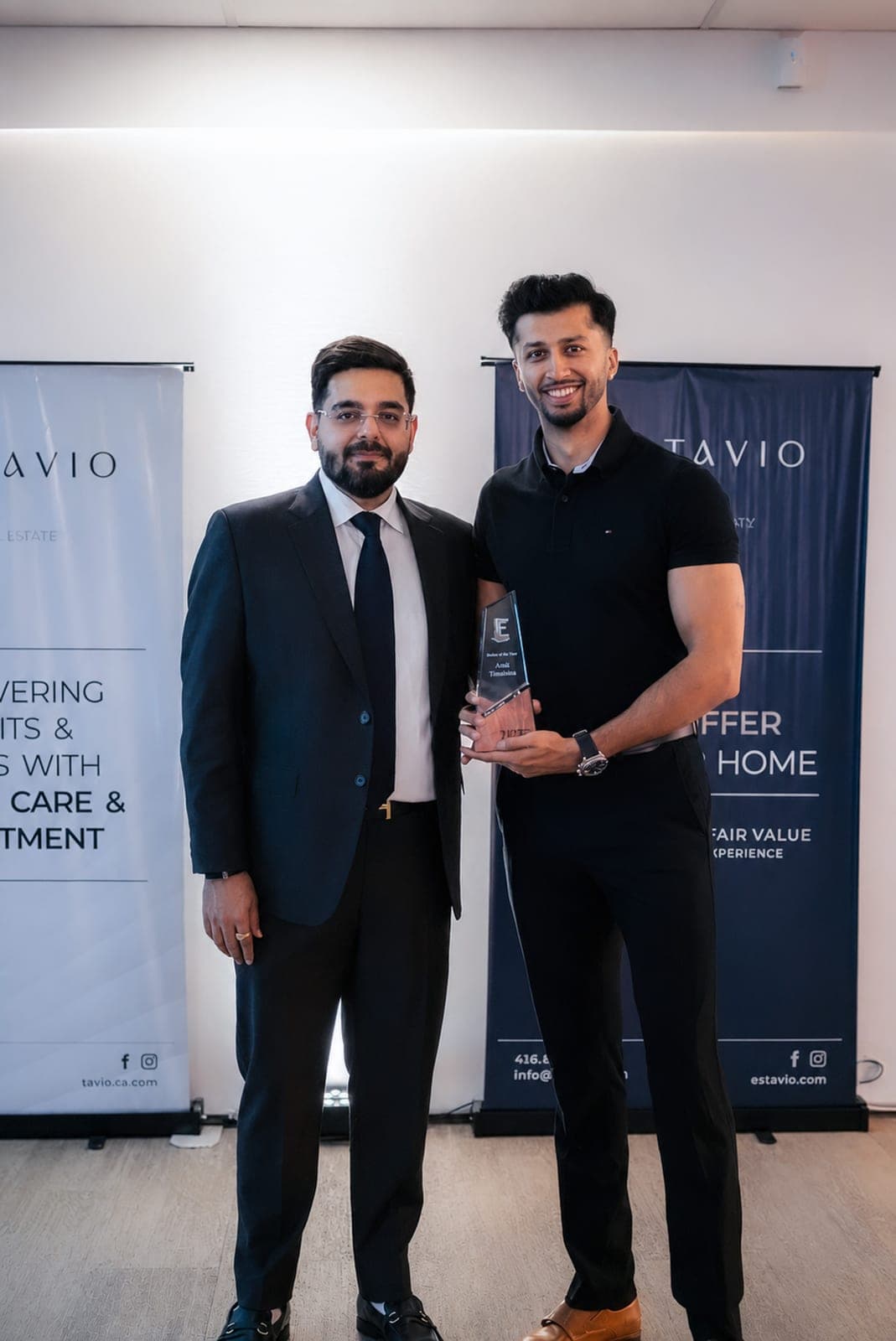 Sahil Chhabra presenting an award to an Estavio agent